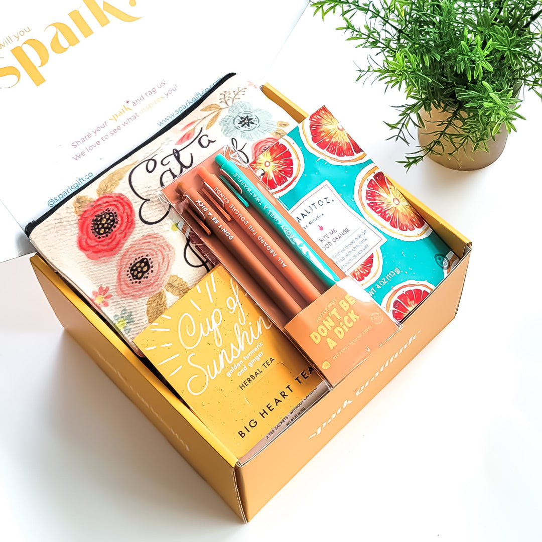 "Don't Be..." Gift Box – A sassy and hilarious gift featuring a cheeky canvas bag, snarky jotter pens, citrusy tea, and tangy peach candy. Perfect for playful pranks and bold personalities.