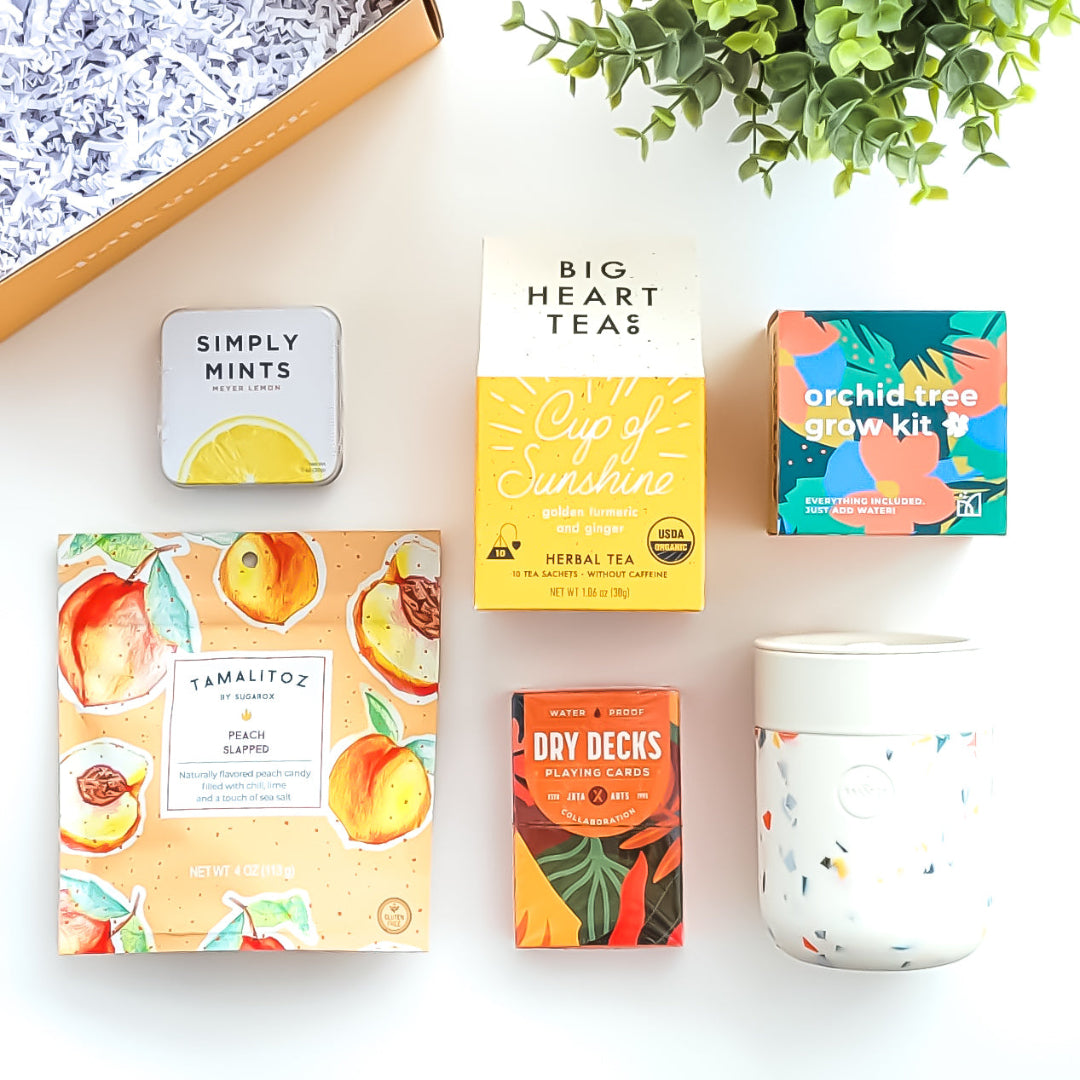 Golden Bloom Gift Box with an orchid tree grow kit, herbal tea sampler, terrazzo ceramic tumbler, assorted lollipop, and peach candy—perfect for nature lovers and thoughtful gifting.