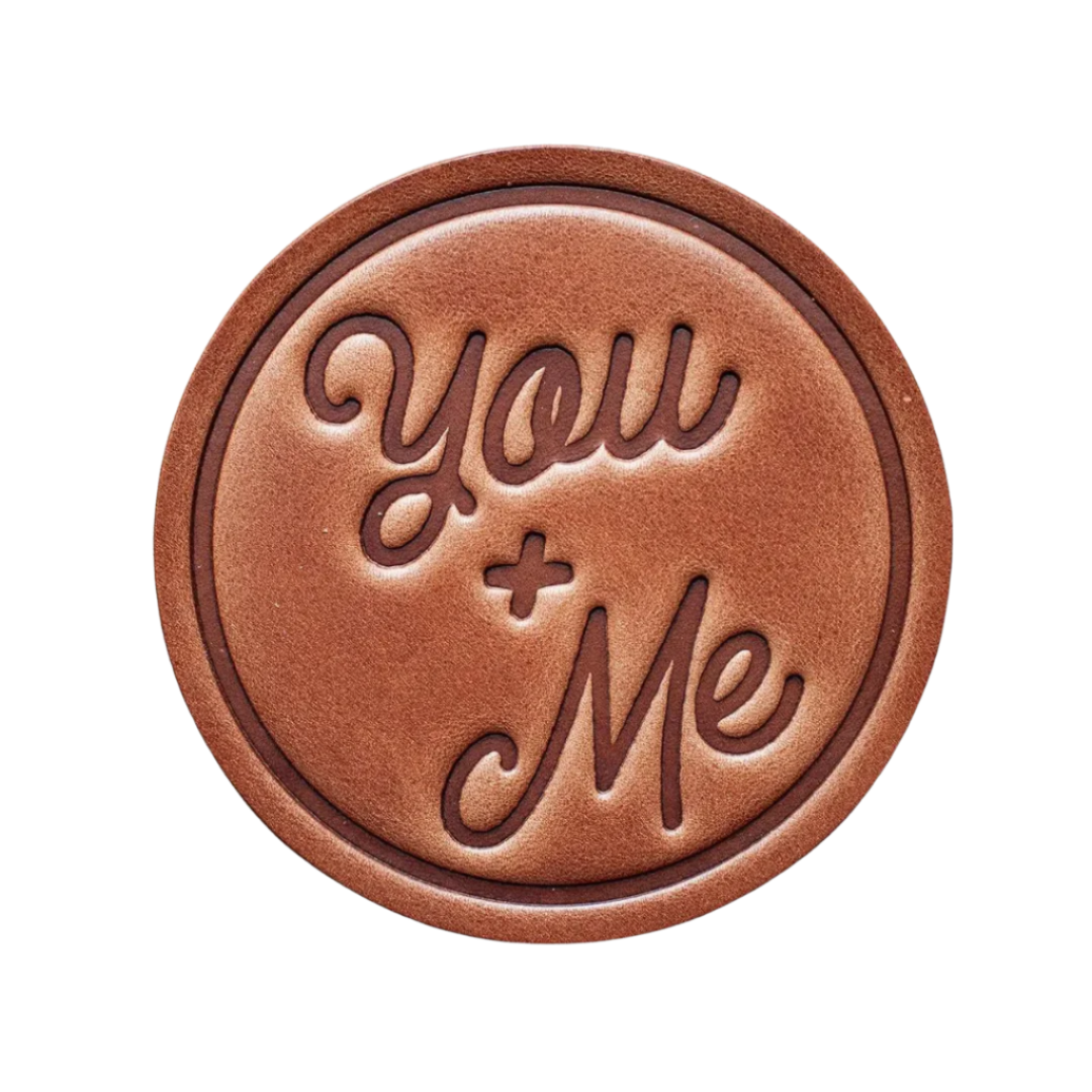 You & Me Leather Coaster β A hand-pressed, handcrafted leather coaster with a minimalist design. Perfect for home, office, or as a thoughtful gift.