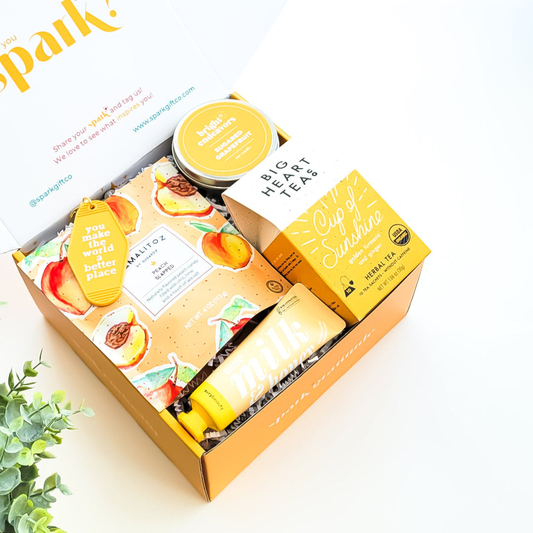 You Are My Sunshine Gift Box with Cup of Sunshine tea, sugared grapefruit candle, milk and honey lotion, peach tamalitz candy, and an uplifting keychain—perfect for brightening someone's day.