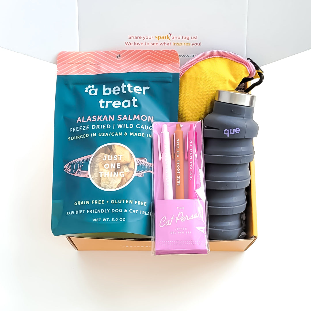 Friends Fur-Ever Cat Gift Box with Alaska salmon treats, collapsible travel bowl, jotter pen set, and collapsible water bottle, —perfect for cat lovers and their feline friends.