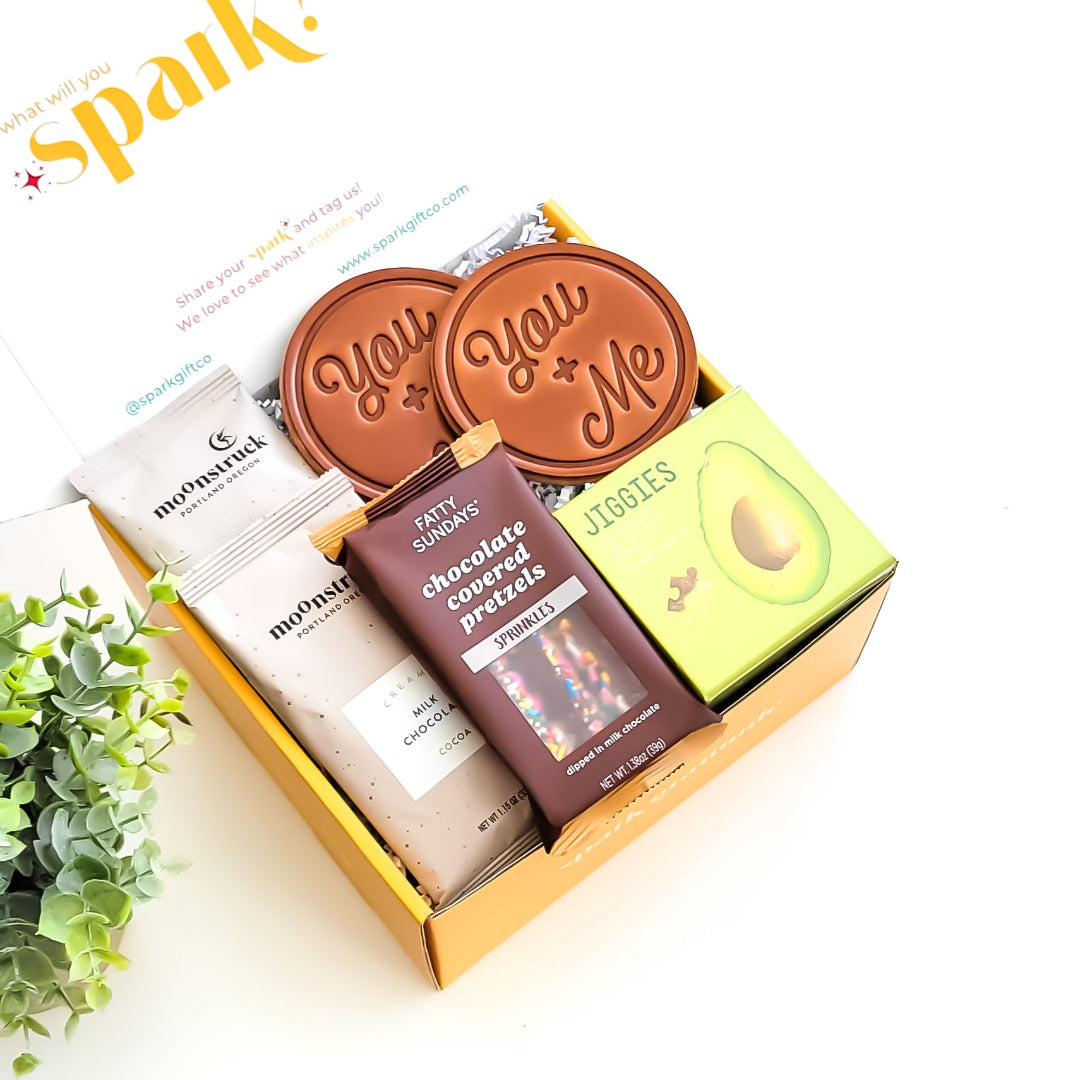 Just the Two of Us Gift Box with hot chocolate, hand-stamped leather coasters, chocolate-covered pretzel sticks, and a 35-piece puzzle—perfect for couples and cozy nights in.