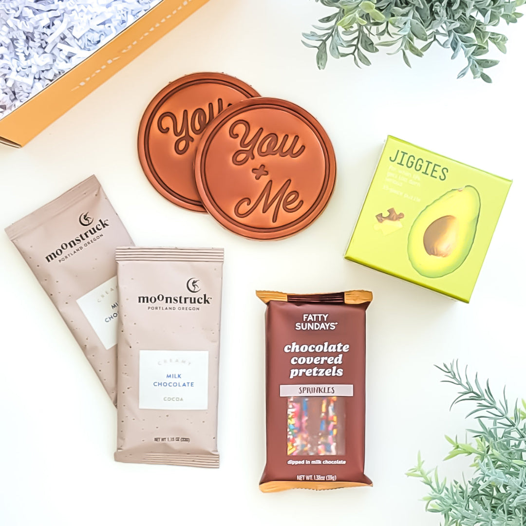 Just the Two of Us Gift Box with hot chocolate, hand-stamped leather coasters, chocolate-covered pretzel sticks, and a 35-piece puzzle—perfect for couples and cozy nights in.