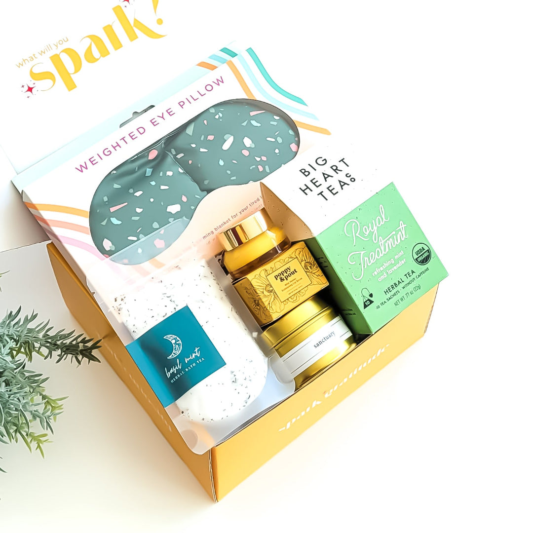 Spa Day Gift Box with a weighted eye mask, organic tea, honey lip scrub, bath salts, travel candle, and a soothing self-care experience—perfect for relaxation and pampering.