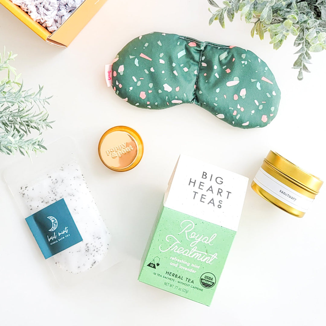 Spa Day Gift Box with a weighted eye mask, organic tea, honey lip scrub, bath salts, travel candle, and a soothing self-care experience—perfect for relaxation and pampering.