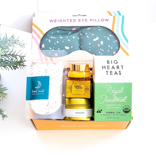 Spa Day Gift Box with a weighted eye mask, organic tea, honey lip scrub, bath salts, travel candle, and a soothing self-care experience—perfect for relaxation and pampering.