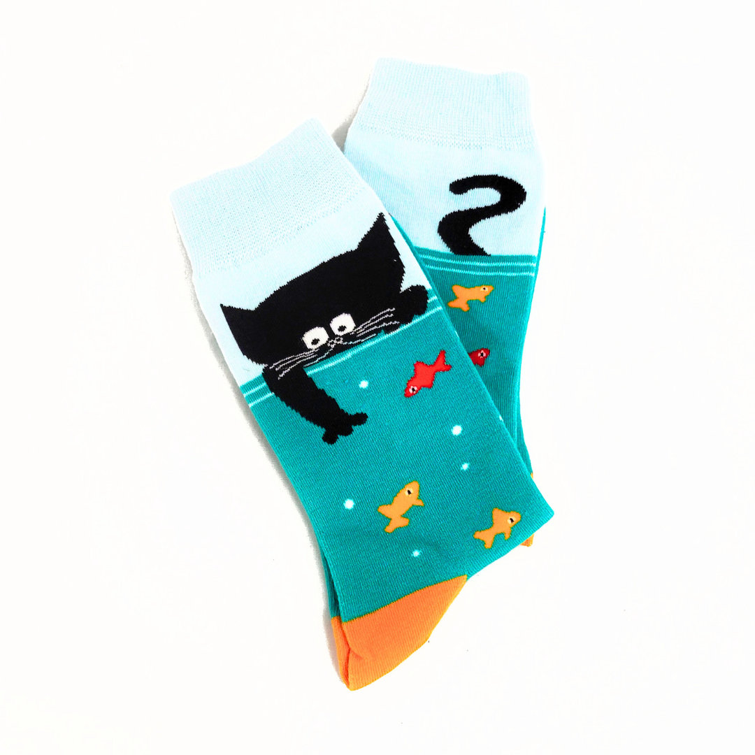 A pair of Purr-fectly Cat-astic Socks featuring a playful cat design. Soft, cozy, and perfect for cat lovers who want to keep their feet warm in style.