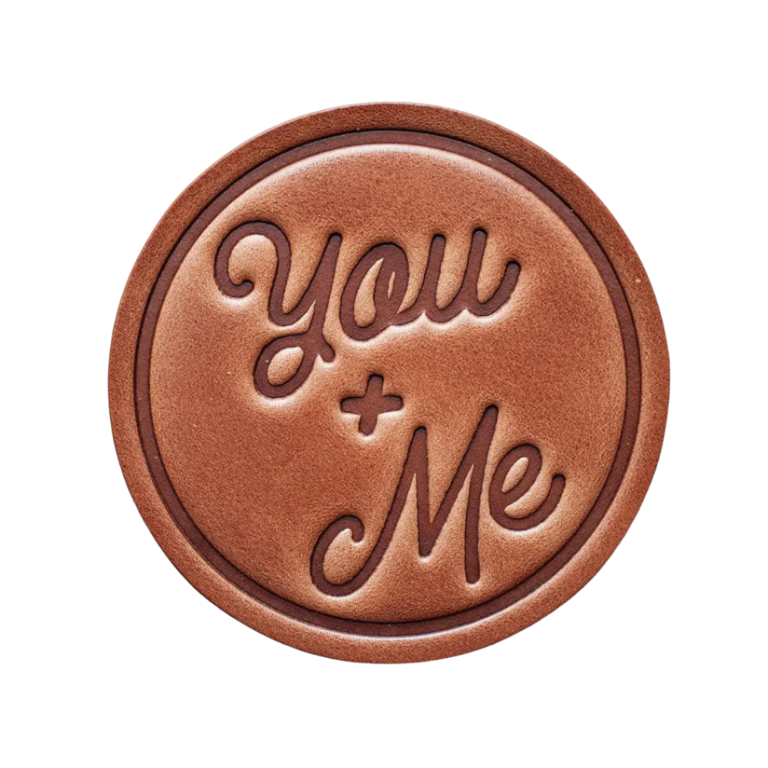 You & Me Leather Coaster – A hand-pressed, handcrafted leather coaster with a minimalist design. Perfect for home, office, or as a thoughtful gift.