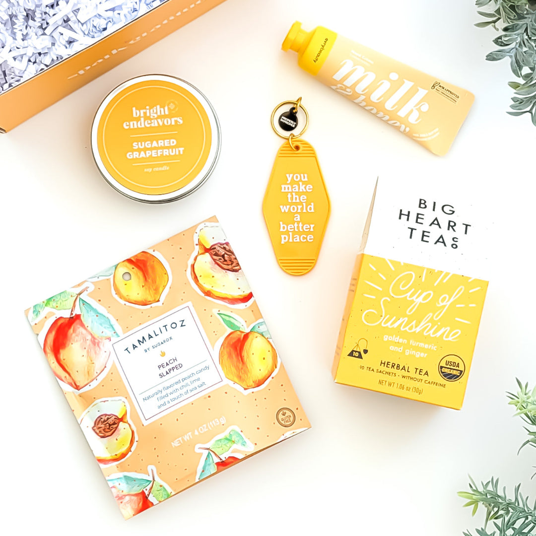 You Are My Sunshine Gift Box with Cup of Sunshine tea, sugared grapefruit candle, milk and honey lotion, peach tamalitz candy, and an uplifting keychain—perfect for brightening someone's day.