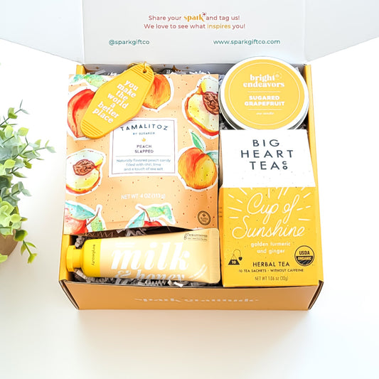 You Are My Sunshine Gift Box with Cup of Sunshine tea, sugared grapefruit candle, milk and honey lotion, peach tamalitz candy, and an uplifting keychain—perfect for brightening someone's day.